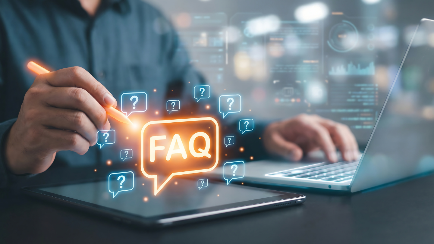 A person using a stylus on a tablet beside a laptop, with a glowing “FAQ” speech bubble and multiple question-mark icons overlaid on the scene.